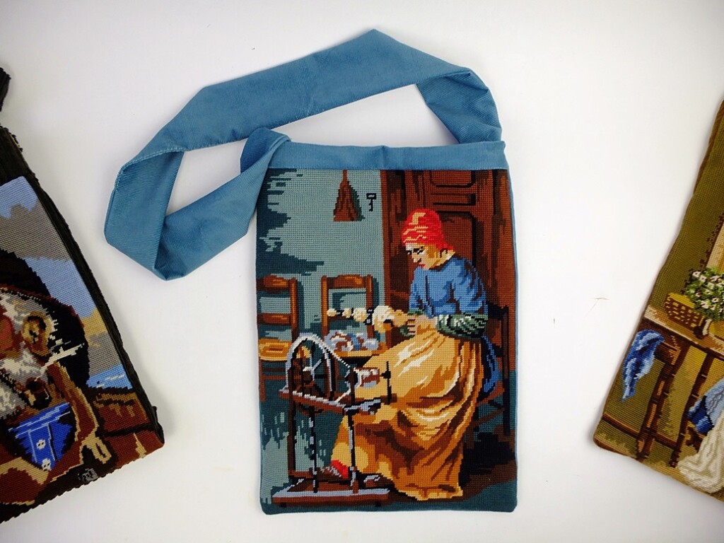 Tapisserietas vrouw achter spinnenwiel