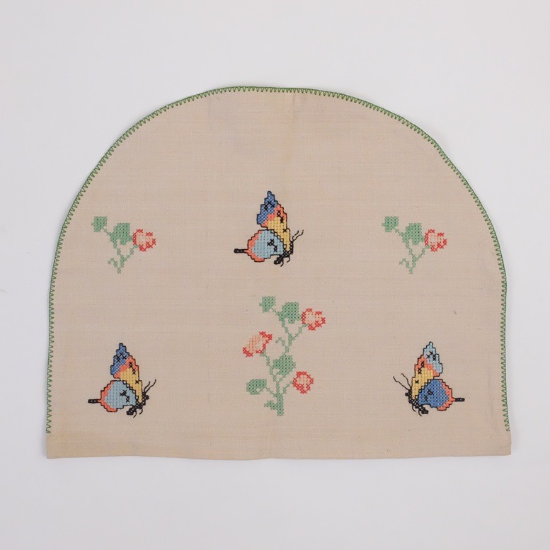 Oude geborduurde theemuts